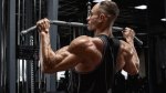 A strong male working out his back muscles with lat pulldown variations