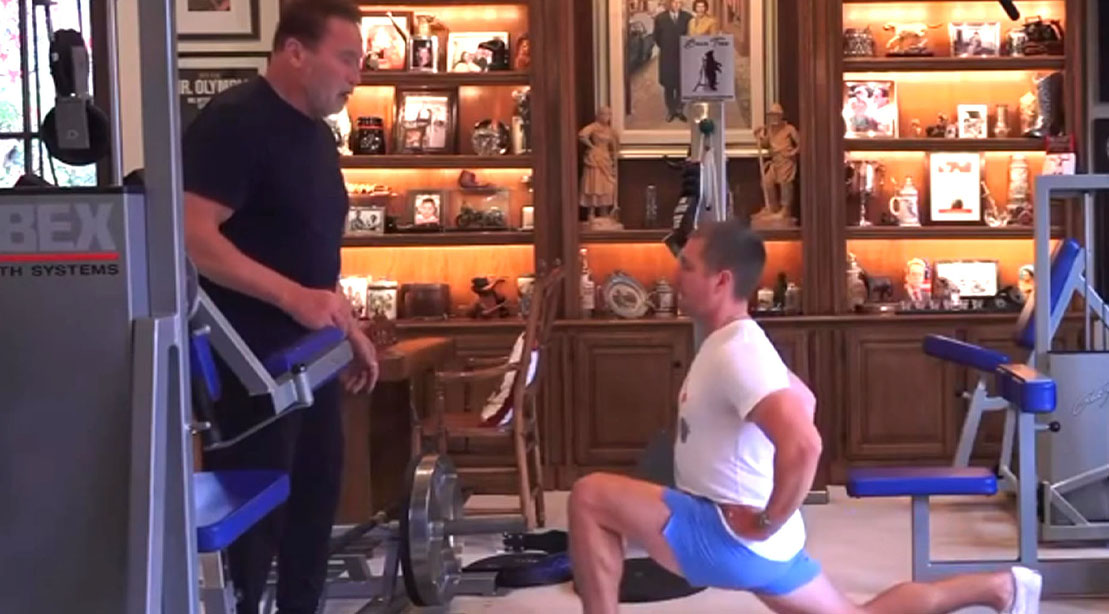 Arnold teaching a student how to properly lunge