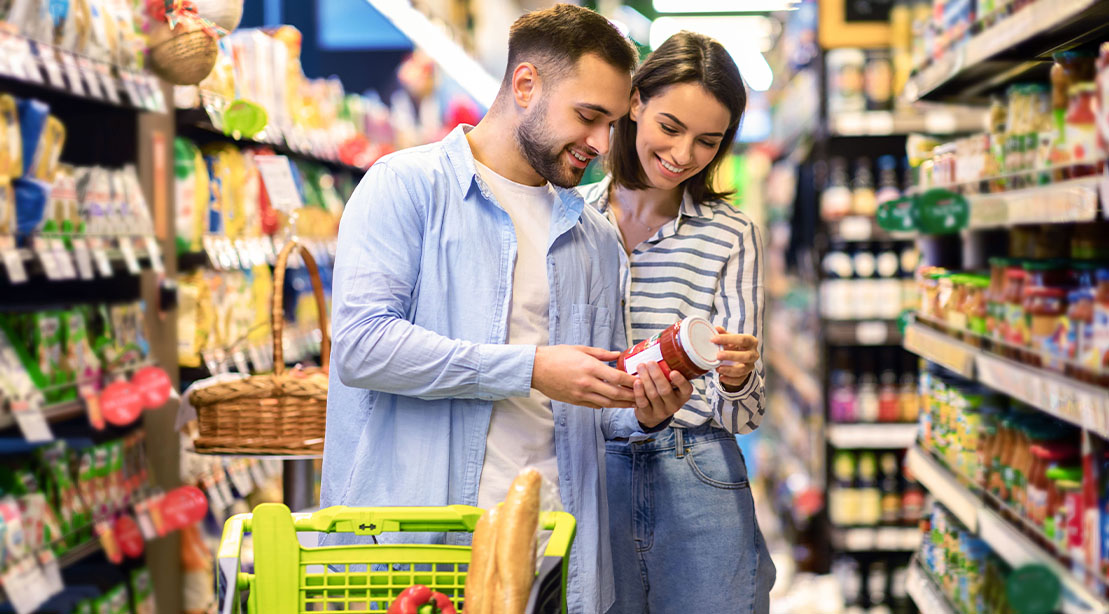 Happy Couple Looking at the label of high-protein foods product