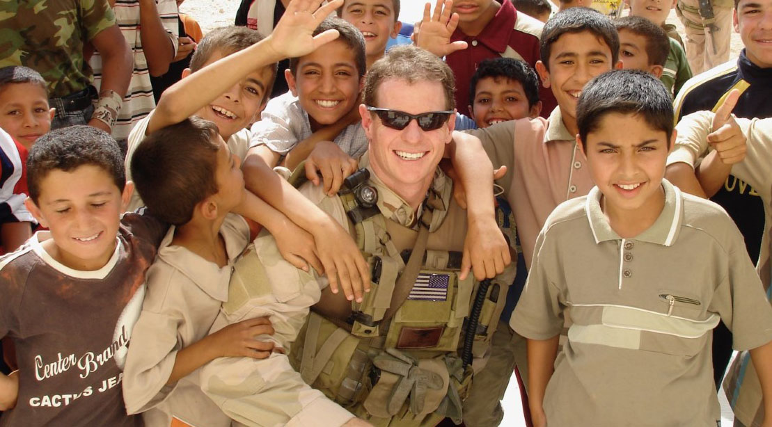 John Doolittle surrounded by middle eastern children