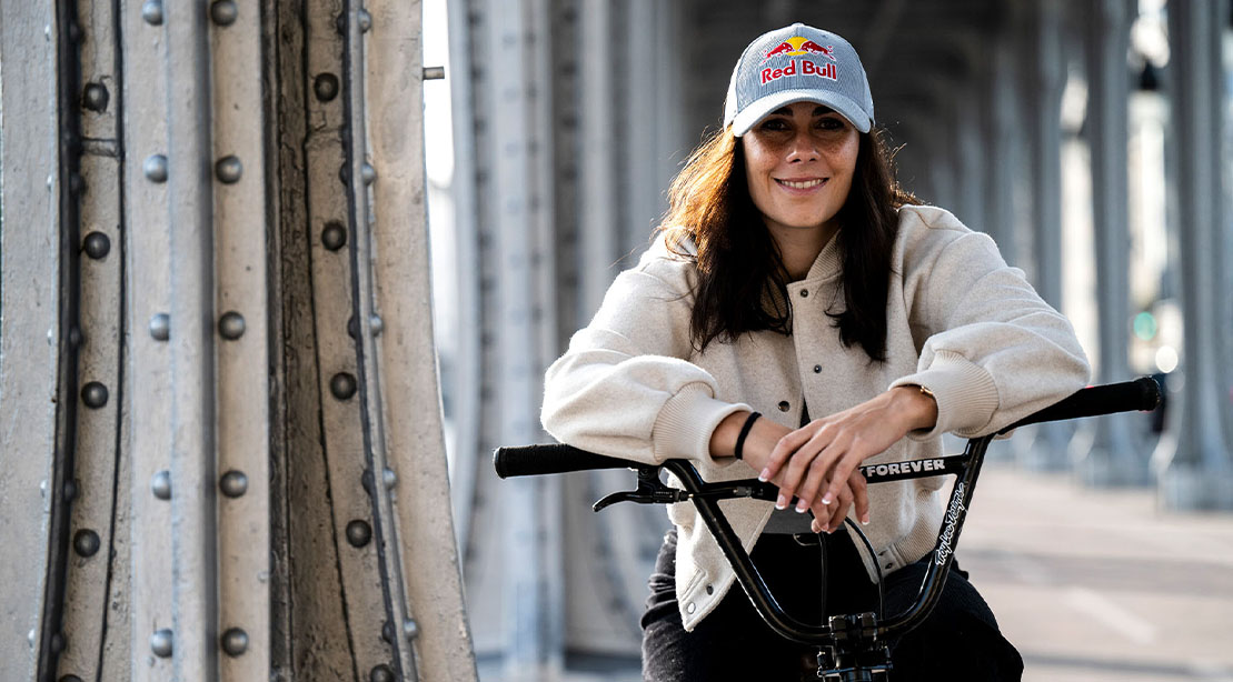 Nikita Ducarroz wearing a red bull cap and on her BMX bike