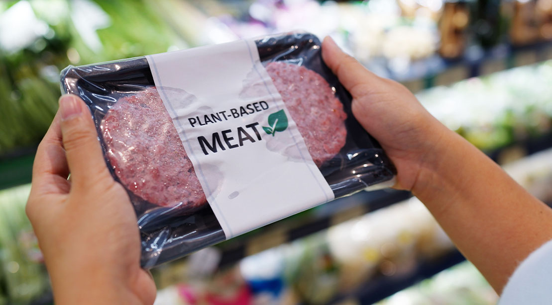 Plant-Based Meat Alternatives packaging in the meat section of a grocery strore