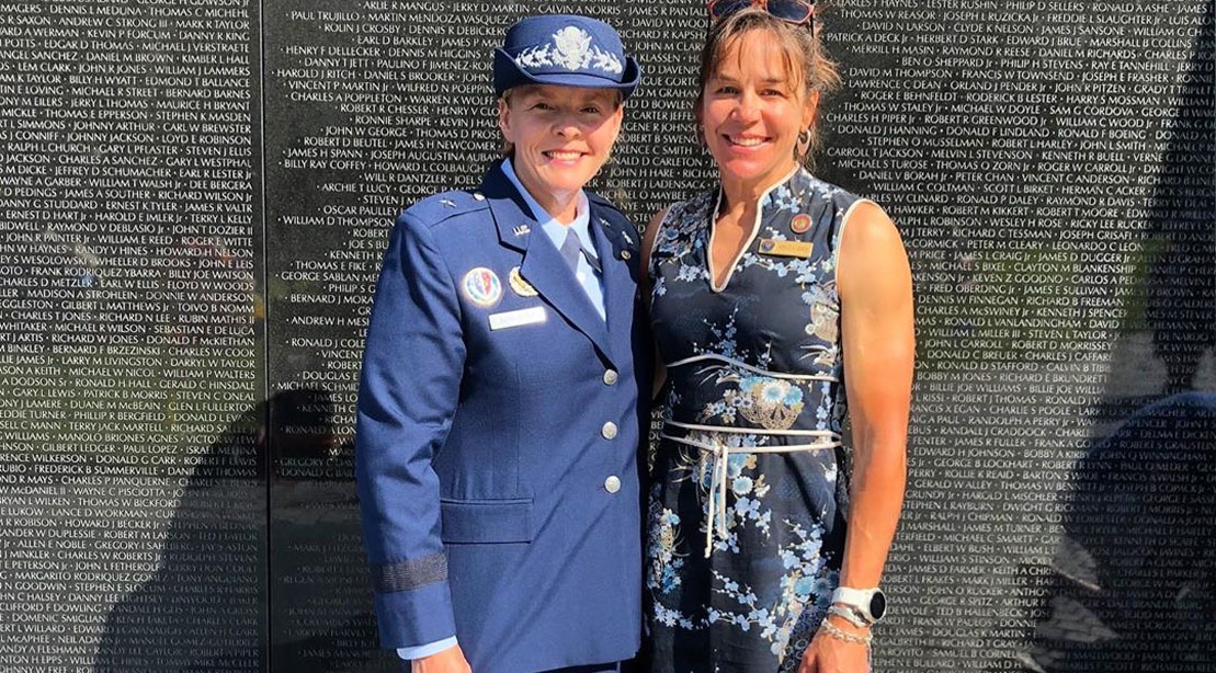 Rebecca Rusch standing infront of a memorial wall