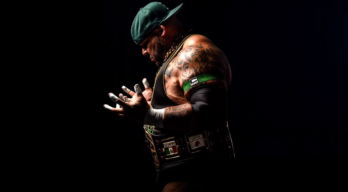 Wrestler Tyrus wearing his championship belts